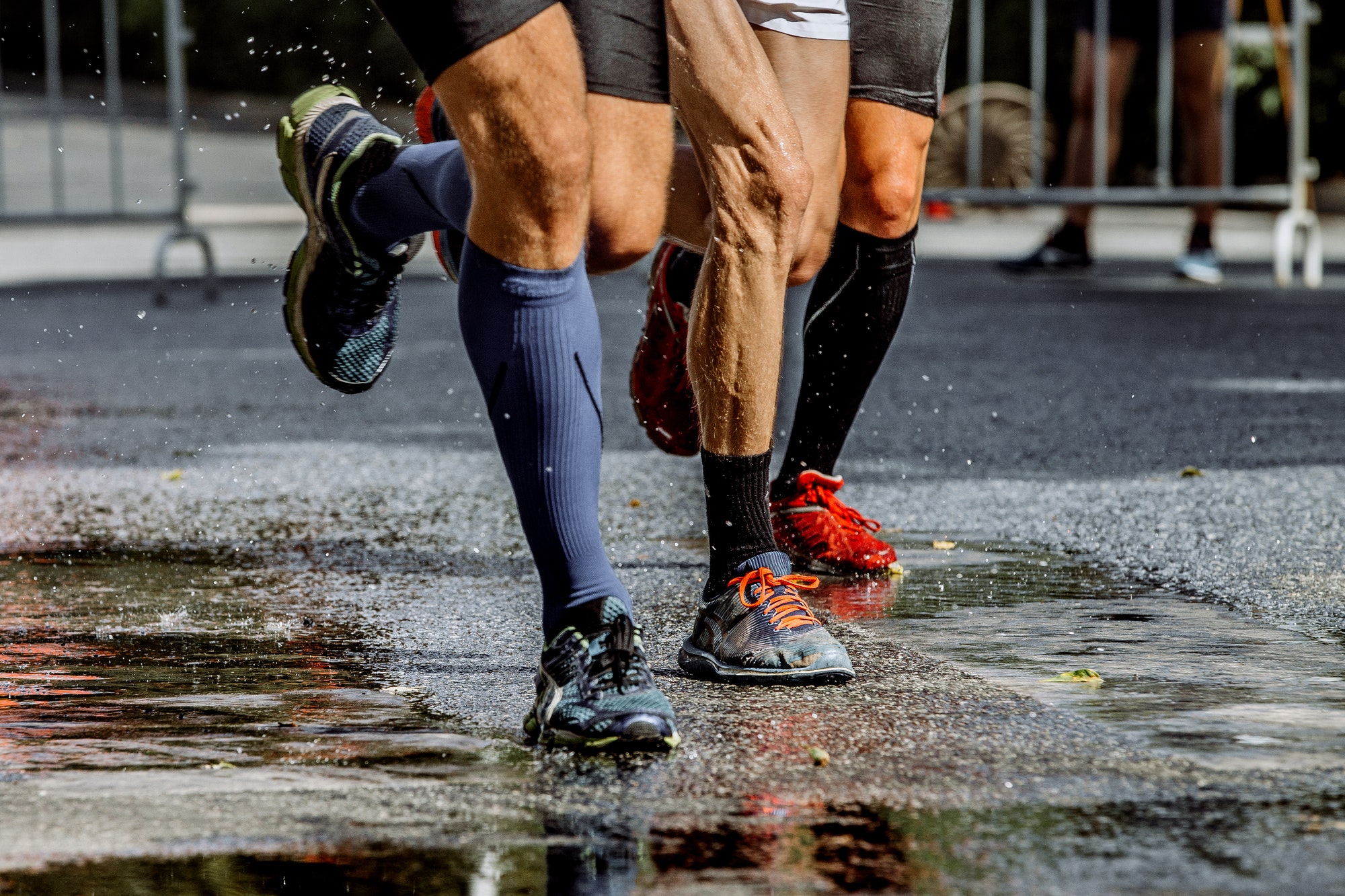 Legs of Three Male Marathon Runners